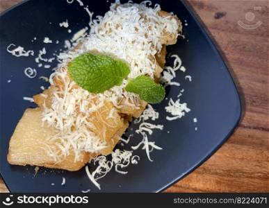 fried cassava with topping cheese on top, Indonesian traditional food, good for tea time or snack