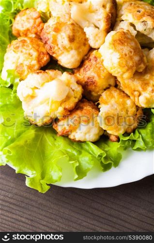 Fried cauliflower closeup on the plate on a table