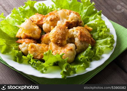 Fried cauliflower closeup on the plate on a table