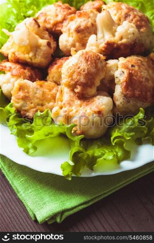 Fried cauliflower closeup on the plate on a table