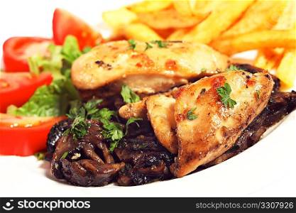 Fried chicken breasts on a bed of mushrooms, served with fries and salad, garnished with parsley