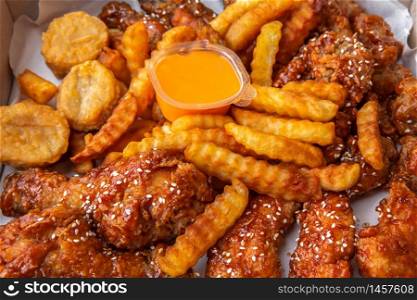 Fried chicken crispy food from chicken and French fries or chips (potato) is a side dish or snack in fastfood restaurant, unhealthy food or fat concept at Thai street food marke