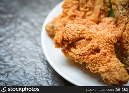 Fried chicken crispy on white plate on dark background