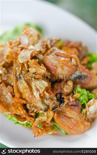 fried chicken . deep fried chicken with fried garlic and fresh vegetable