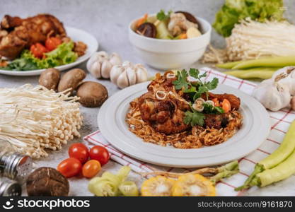 Fried chicken leg with tomato, chili, fried onion, lettuce, corn, and needle mushroom.