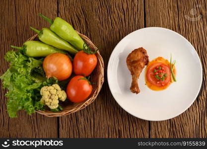 Fried chicken legs on a white plate with sauce.