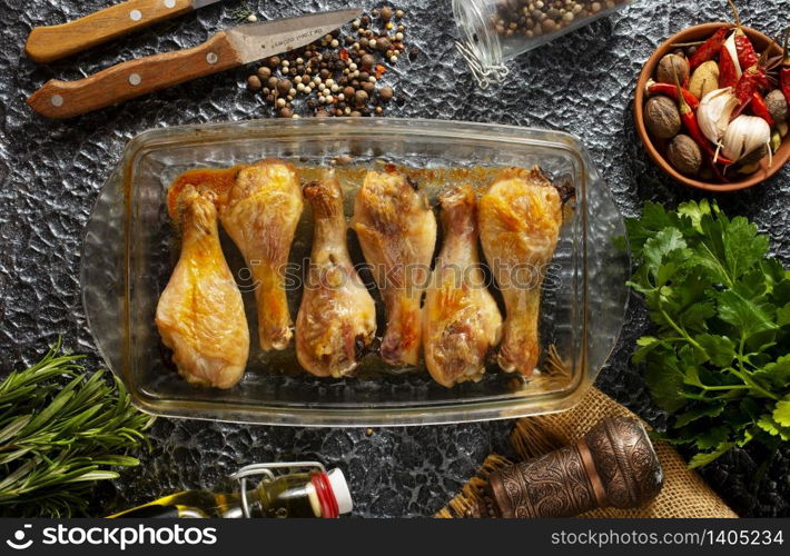 Fried chicken legs on glass plate with lemon chilli herbs and spices