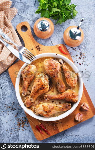 fried chicken legs on plate and on a table