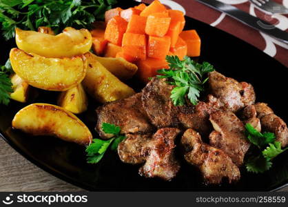 Fried chicken liver with vegetable garnish, baked pumpkin and apple.