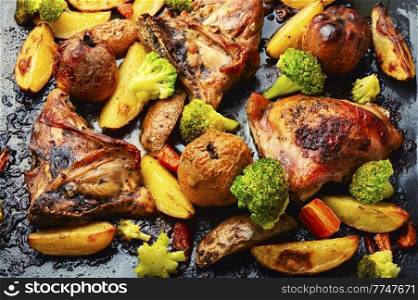 Fried chicken meat in vegetables and fruits. Roasted meat. Close up, food background. Grilled chicken meat on baking sheet