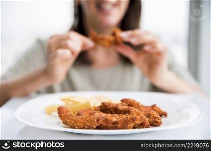 fried chicken near eating woman