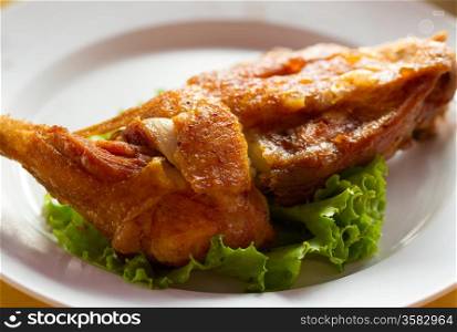 fried chicken on a plate with lettuce