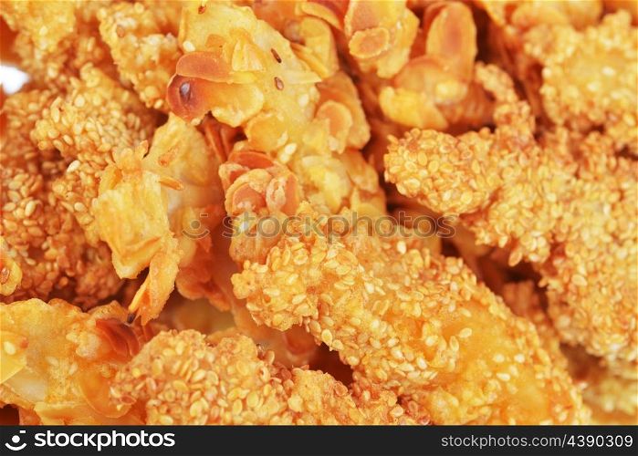 Fried chicken pieces with sesame seeds and nuts