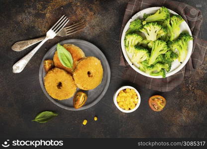 fried chicken rings with broccoli on plate