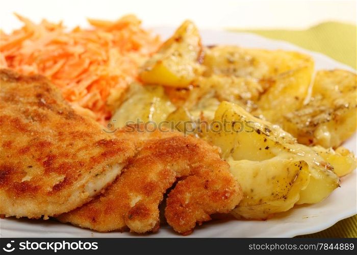Fried chicken roasted potatos with cheese and vegetables carrot salad