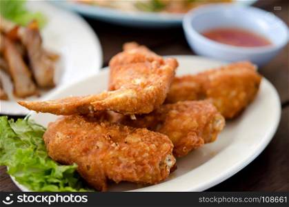 Fried chicken wings on dish.