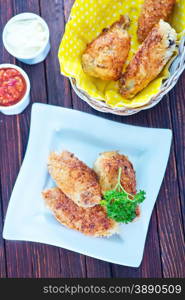 fried chicken wings on plate and on a table