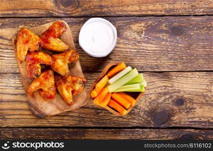fried chicken wings on wooden board