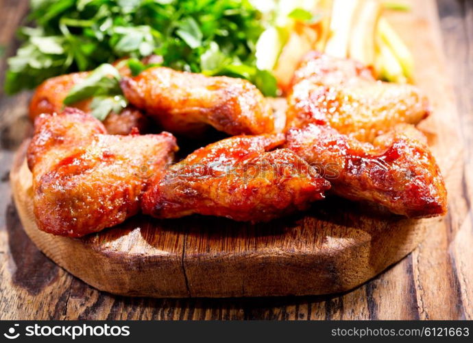 fried chicken wings on wooden board