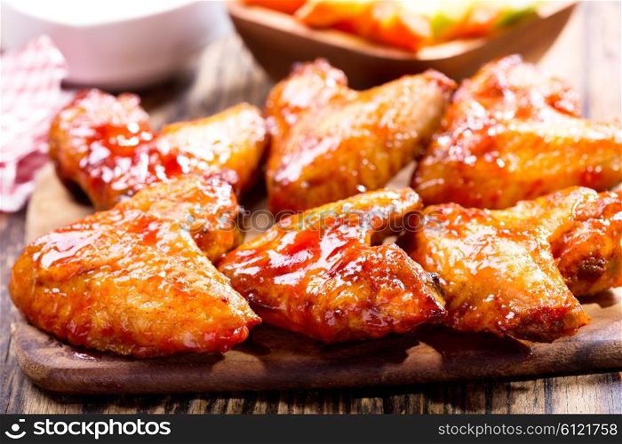 fried chicken wings on wooden board