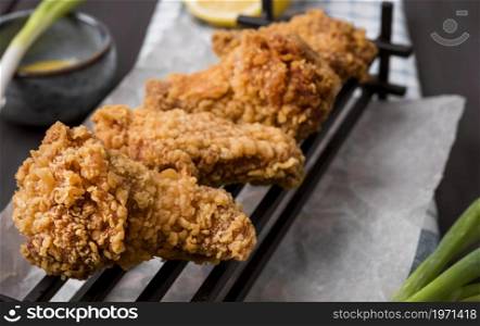 fried chicken wings tray green onions. High resolution photo. fried chicken wings tray green onions. High quality photo