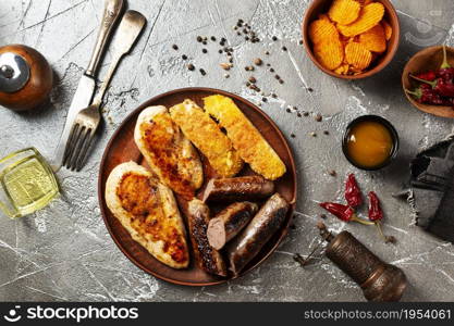 Fried chicken with sausages and white fish on plate