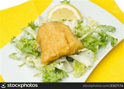 fried cod fish with fresh salad and lemon slice