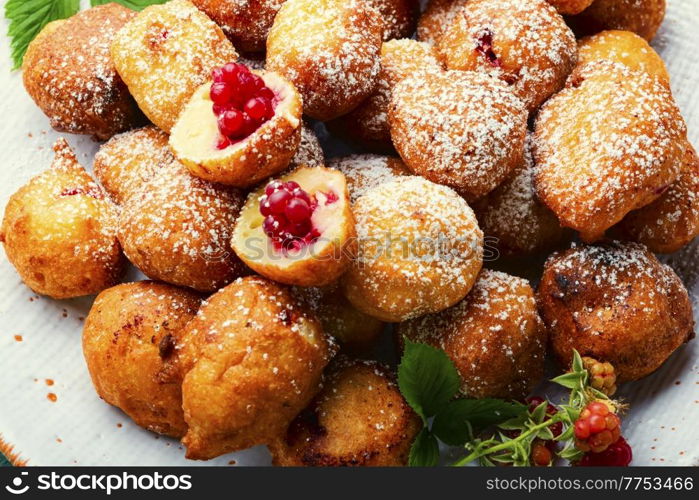 Fried cottage cheese donuts with berries.Donuts on a plate. Cottage cheese donuts with raspberries