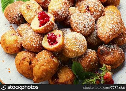 Fried cottage cheese donuts with berries.Donuts on a plate. Cottage cheese donuts with raspberries