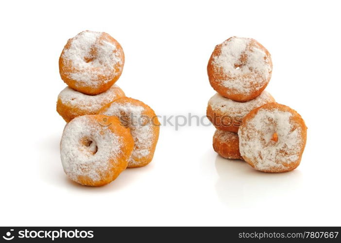 Fried donuts in powdered sugar on a white background (isolated)