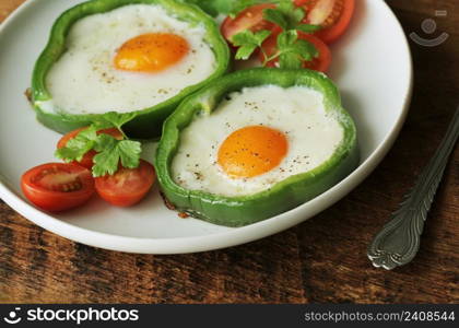 Fried egg in the ring of the bell peppers with herbs .. Fried egg in the ring of the bell peppers with herbs