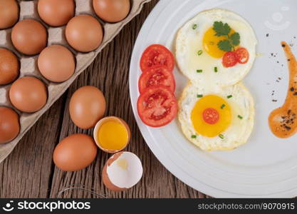 Fried egg on a white plate with sliced   Spring onion and sliced   tomatoes