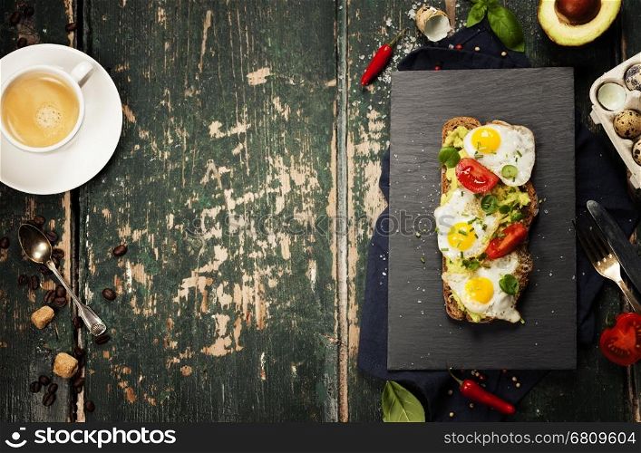 Fried egg sandwich: quail eggs, avocado and cheese on whole wheat bread