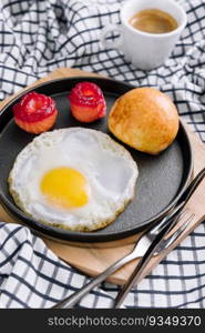 fried egg with salted red fish in a pan with coffee