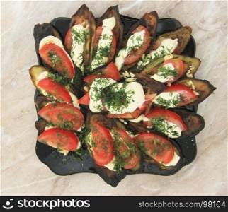 Fried eggplants and fresh tomato with souce and herbs