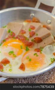 fried eggs and sliced chinese sausage, vietnamese sausage , asian breakfast