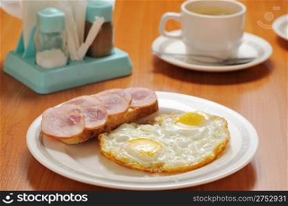 Fried eggs. Breakfast with tea on a table
