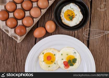 Fried eggs in a frying pan and raw eggs, organic food for good health, high in protein.