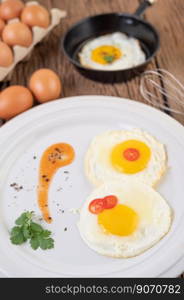 Fried eggs in a frying pan and raw eggs, organic food for good health, high in protein.