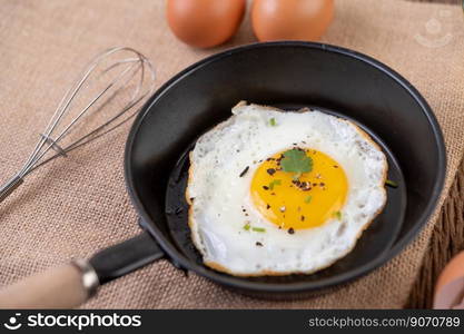 Fried eggs in a frying pan and raw eggs, organic food for good health, high in protein