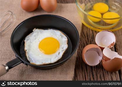 Fried eggs in a frying pan and raw eggs, organic food for good health, high in protein