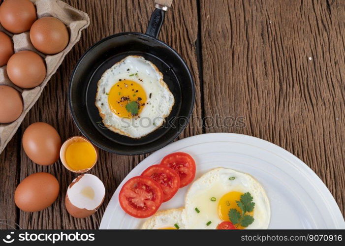 Fried eggs in a frying pan and raw eggs, organic food for good health, high in protein.