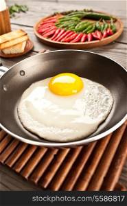 Fried eggs on a wooden table, breakfast