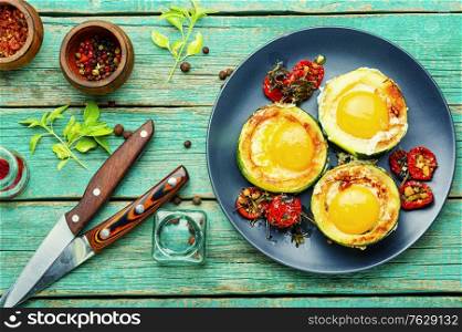 Fried eggs with cherry tomatoes in plate.Fried eggs for healthy breakfast. Fried eggs in zucchini