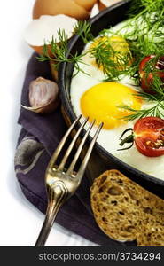 Fried eggs with fresh vegetables over white