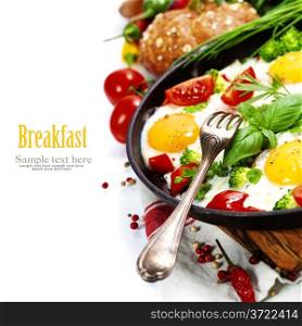 Fried eggs with fresh vegetables over white (health, breakfast or vegetarian concept)