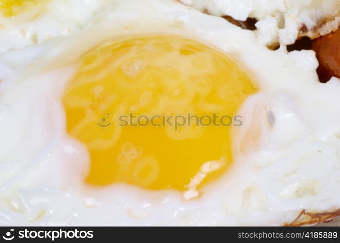 Fried eggs with meat and salad on the dish