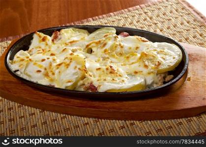 Fried eggs with potato and spring onions