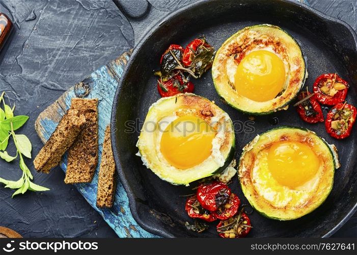 Fried eggs with tomatoes and bread.Fried eggs in cast iron frying pan. Scrambled eggs on frying pan