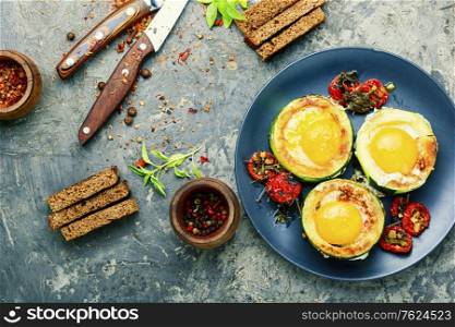 Fried eggs with tomatoes and bread in plate. Fried eggs in zucchini